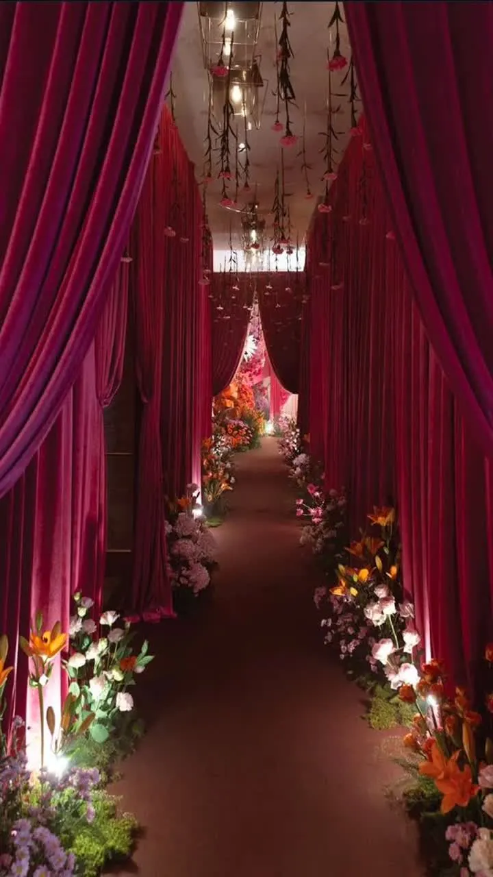 Draped wedding aisle with floral arrangements