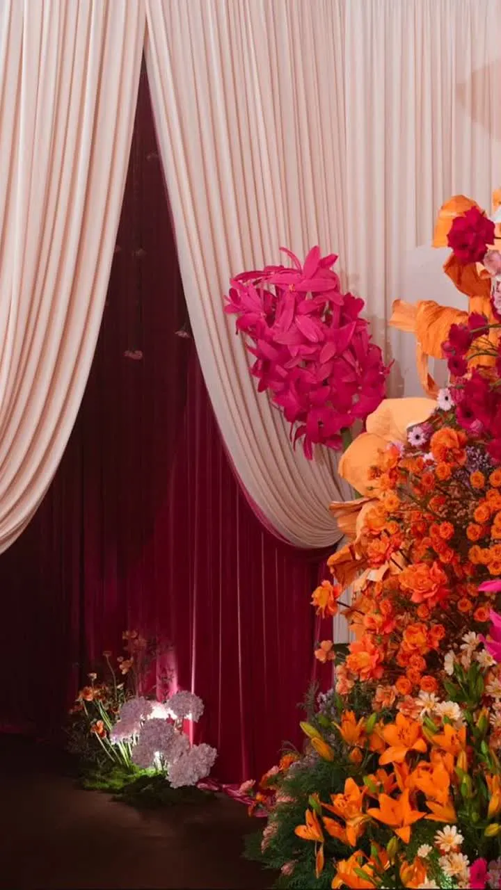 Red drapery and floral wedding decor detail
