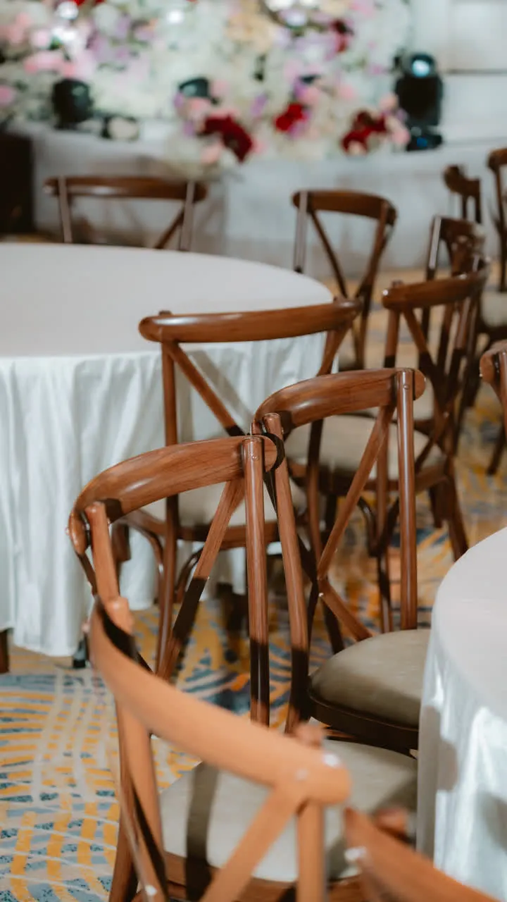 Reception table and chair detail with floral backdrop